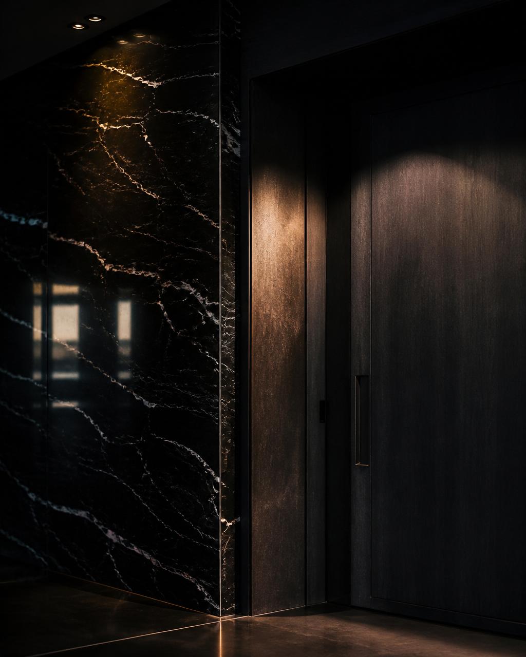 Black marble wall meeting a charcoal door in a luxury foyer